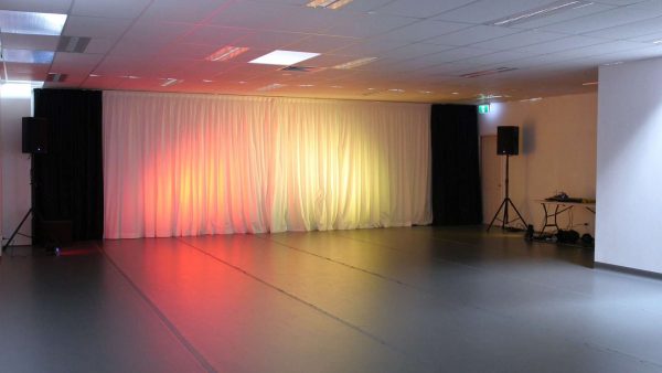 Studio A with lights on curtain at front of room